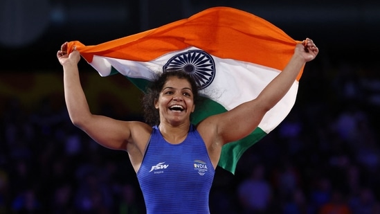 India's Sakshi Malik celebrates her win against Canada's Ana Godinez Gonzalez in the women's 62kg gold medal wrestling match on day nine of the Commonwealth Games.(AFP)