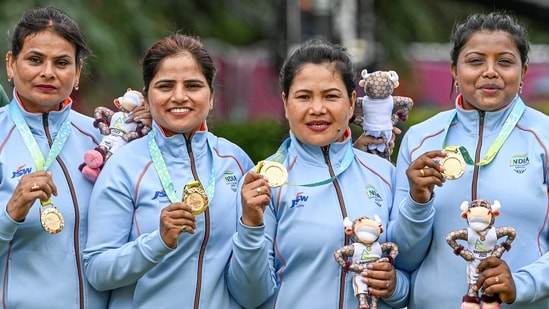 India's Lovely Choubey, Pinki, Nayanmoni Saikia and Rupa Rani Tirkey pose for photos after winning the Lawn Bowls Women's Fours gold at the Commonwealth Games 2022 (CWG).It was India's first ever medal finish in Lawn Bowls.(PTI)