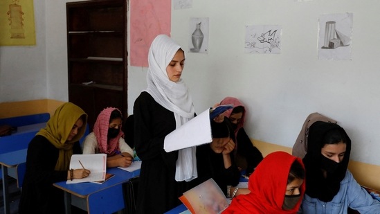 Kerishma Rasheedi, 16, reads during a class at a private school class in Kabul, Afghanistan, August 3, 2022.&nbsp;(REUTERS)