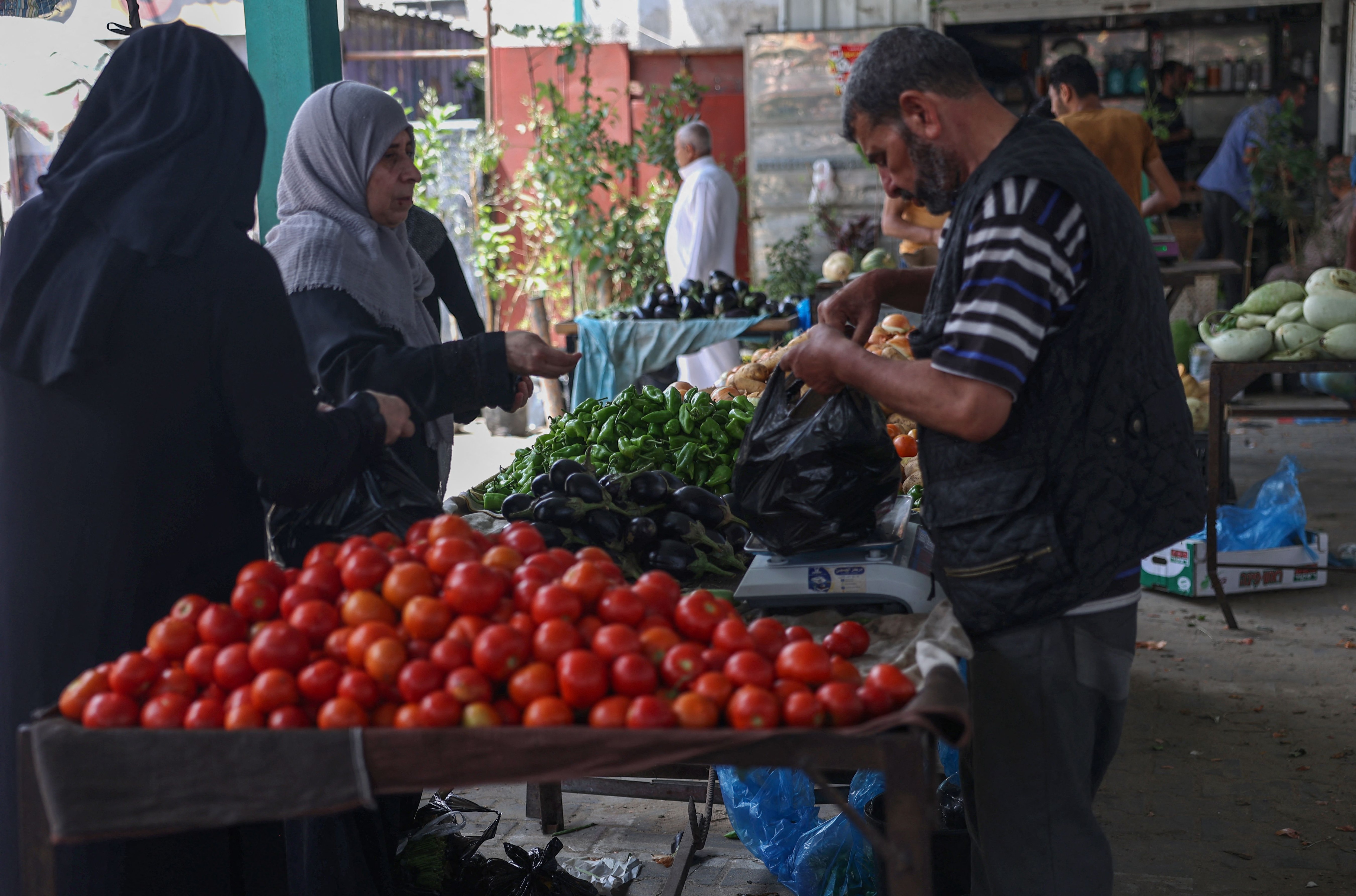 Palestinians buy fresh produce from street stalls in Rafah town in the southern Gaza Strip, as a truce with Israel holds following three days of conflict. (Photo by SAID KHATIB/AFP) Palestinians buy fresh produce from street stalls in Rafah town in the southern Gaza Strip, as a truce with Israel holds following three days of conflict. (Photo by SAID KHATIB/AFP)