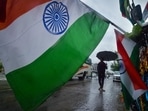 A hawker selling Indian flags on a rainy day, ahead of Independence Day celebrations at Ring Road, in New Delhi, India. (HT_PRINT) A hawker selling Indian flags on a rainy day, ahead of Independence Day celebrations at Ring Road, in New Delhi, India. (HT_PRINT)