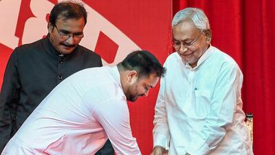 Bihar deputy chief minister Tejashwi Yadav seeks blessings from chief minister Nitish Kumar, in Patna on Wednesday. (PTI) Bihar deputy chief minister Tejashwi Yadav seeks blessings from chief minister Nitish Kumar, in Patna on Wednesday. (PTI)