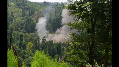 Smoke billows from a house during an encounter in Waterhail village in Budgam district of Jammu and Kashmir on Wednesday (HT Photo/Waseem Andrabi) Smoke billows from a house during an encounter in Waterhail village in Budgam district of Jammu and Kashmir on Wednesday (HT Photo/Waseem Andrabi)