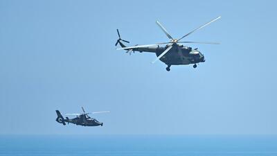 Chinese military helicopters fly past Pingtan island, one of mainland China's closest points from Taiwan, in Fujian province on August 4, 2022. (AFP) Chinese military helicopters fly past Pingtan island, one of mainland China's closest points from Taiwan, in Fujian province on August 4, 2022. (AFP)