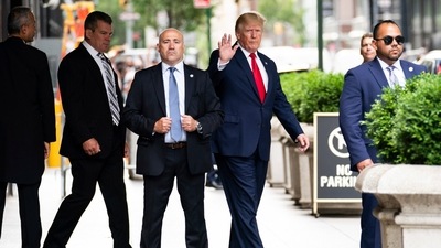 Former President Donald Trump waves as he departs Trump Tower. (AP Photo) (AP) Former President Donald Trump waves as he departs Trump Tower. (AP Photo) (AP)