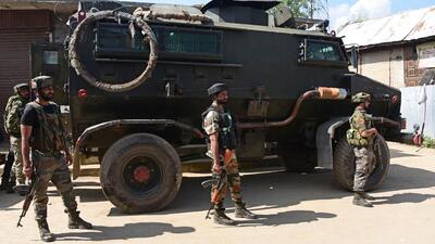 Security personnel stand guard during an encounter in Budgam on Wednesday. (Waseem Andrabi/HT)