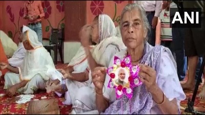 One of the women carrying the handmade rakhi featuring PM Modi's face. (ANI)