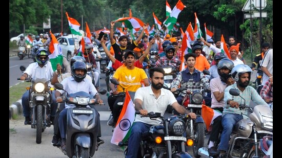 During the tiranga rally organised by the Bharatiya Janata Yuva Morcha in Chandigarh on Tuesday evening, many riders were seen without protective headgear. (Keshav SIngh/HT)