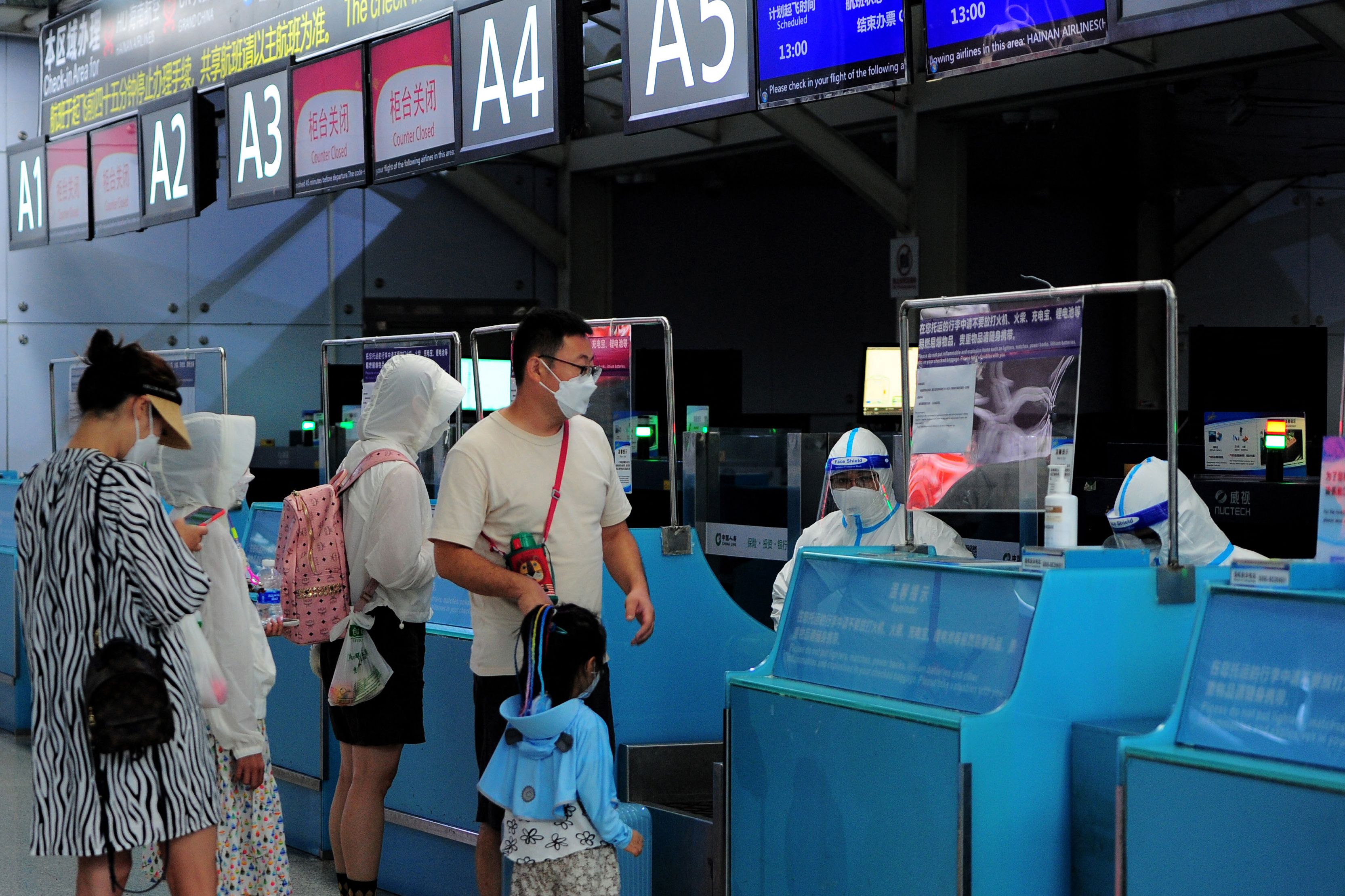 Tourists go through pre-departure formalities at the Sanya Phoenix airport as stranded holidaymakers prepare to leave the Covid-hit resort city of Sanya on Hainan Island in China. (Photo by Str/AFP) Tourists go through pre-departure formalities at the Sanya Phoenix airport as stranded holidaymakers prepare to leave the Covid-hit resort city of Sanya on Hainan Island in China. (Photo by Str/AFP)
