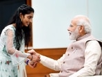 Prime Minister Narendra Modi celebrated Raksha Bandhan on Thursday with the daughters of staff members working at his office. In the photos, young girls can be seen tying rakhis on his wrist.(ANI )