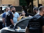 A bank employee leaves the Federal Bank of Lebanon, after being held hostage by an armed customer demanding the return of his bank deposits, in the capital Beirut's Hamra street.(AFP) A bank employee leaves the Federal Bank of Lebanon, after being held hostage by an armed customer demanding the return of his bank deposits, in the capital Beirut's Hamra street.(AFP)