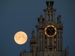 The Supermoon is seen behind the Lomonosov Moscow State University in Moscow, Russia, on May 2020.&nbsp;