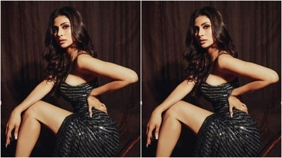 Mouni looked super stylish in a black and silver slip gown that featured corset details, midriff-baring details and one thigh high slit. (Instagram/@imouniroy)