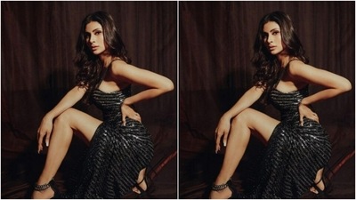 Styled by fashion stylist Rishika Devnani, Mouni wore her tresses open in soft wavy curls with a middle part. (Instagram/@imouniroy)