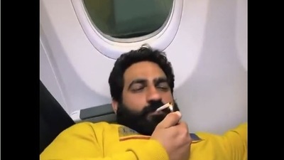 Screenshot from the viral video of Bobby Kataria smoking inside a plane.&nbsp;