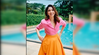 Tamannaah Bhatia's outfit comes with a pink cropped blazer and a high-rise orange skirt featuring heart prints. (Instagram/@stylebyami) Tamannaah Bhatia's outfit comes with a pink cropped blazer and a high-rise orange skirt featuring heart prints. (Instagram/@stylebyami)