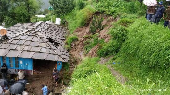 Two women were killed after a flash flood triggered a mudslide that hit their house at Khadel village in Anni sub division of Kullu district in Himachal Pradesh on Thursday morning. Ten shops were also damaged in the area. (Aqil Khan/HT)