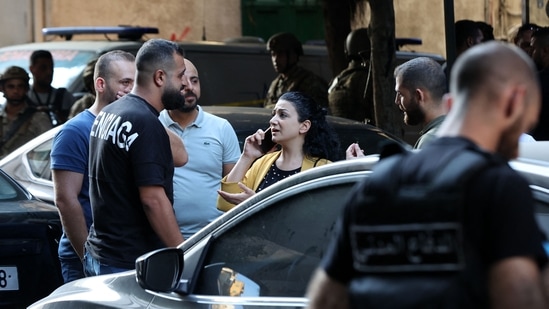 A bank employee leaves the Federal Bank of Lebanon, after being held hostage by an armed customer demanding the return of his bank deposits, in the capital Beirut's Hamra street.(AFP)