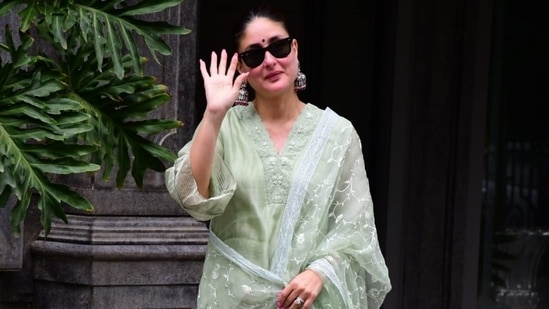 Kareena Kapoor waves at paparazzi.