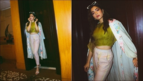 Rashmika Mandanna glamed up for an outing in a green crop top, high-rise stripped trousers and strappy stilettoes. She teamed her look a floral stripped cape.(Instagram/rashmika_mandanna)