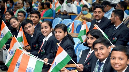 Students holding National flags attend the felicitation of 'Super 25' students of Veer Gatha contest organised by Gallantry Awards Portal of India in New Delhi on Friday. (ANI)