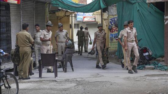 Udaipur: Security personnel deployed outside the closed shop of tailor Kanhaiya Lal days after his murder in Udaipur on July 3. (PTI File Photo)