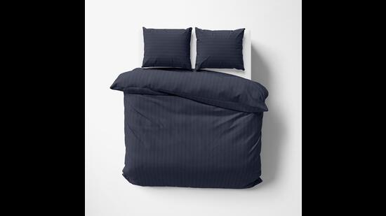 This tone-on-tone striped duvet cover feels good and looks both masculine and sophisticated. (Egyptian cotton duvet set in Navy blue by Vaaree)