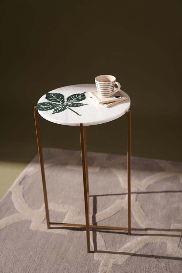 A slim corner table is ideal to place a lamp, ash tray or your coffee up. (Handmade marble table with inlay work and foldable stand by Jaypore) A slim corner table is ideal to place a lamp, ash tray or your coffee up. (Handmade marble table with inlay work and foldable stand by Jaypore)