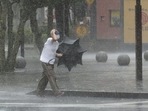 A man walks on the street in the heavy rain caused by Tropical Storm Meari in Hamamatsu, central Japan.