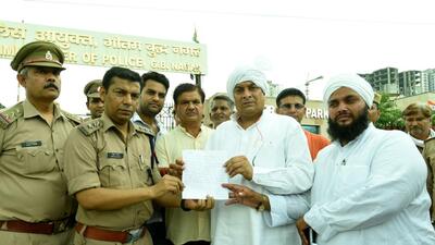 Noida, India- August 13, 2022: Members of the Tyagi community gives a memorandum to ACP Abdul Qadir outside the Police Commissioner's office, at Noida Sector 108 in Noida, India, on Saturday, August 13, 2022. (Photo by Sunil Ghosh / Hindustan Times) (Hindustan Times) Noida, India- August 13, 2022: Members of the Tyagi community gives a memorandum to ACP Abdul Qadir outside the Police Commissioner's office, at Noida Sector 108 in Noida, India, on Saturday, August 13, 2022. (Photo by Sunil Ghosh / Hindustan Times) (Hindustan Times)