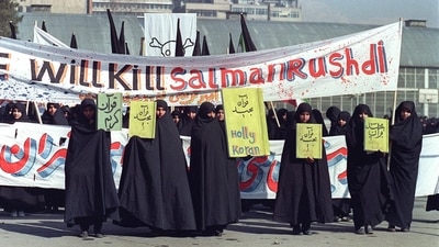 Iranian women are seen holding banners which read ‘Holly Koran' and ‘Kill Salman Rushdie' during a demonstration against British writer Salman Rushdie in Tehran. (AFP) Iranian women are seen holding banners which read ‘Holly Koran' and ‘Kill Salman Rushdie' during a demonstration against British writer Salman Rushdie in Tehran. (AFP)