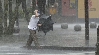 A man walks on the street in the heavy rain caused by Tropical Storm Meari in Hamamatsu, central Japan. (Photo by Kyodo via REUTERS)