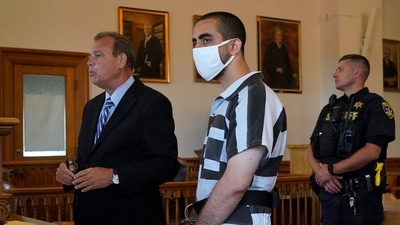 Hadi Matar, 24, center, listens to his public defense attorney Nathaniel Barone, left, addresses the judge while being arraigned in the Chautauqua County Courthouse in Mayville, New York. (AP)