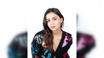 Alia Bhatt's cardigan features a plunging V-neckline, drop shoulders and the Chanel logo printed in multiple colours. (Instagram/@stylebyami) Alia Bhatt's cardigan features a plunging V-neckline, drop shoulders and the Chanel logo printed in multiple colours. (Instagram/@stylebyami)