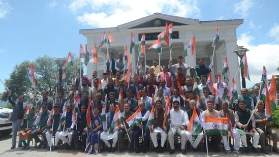 Himachal Pradesh Chief Minister Jai Ram Thakur and legislators hold national flag as part of the ‘Har Ghar Tiranga’ campaign during the ongoing monsoon session at Vidhansabha, Shimla, Himachal Pradesh on August 12.(ANI)