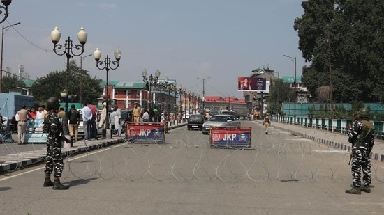 (File) Security personnel stand guard near a barbed wire in Srinagar on Sunday. (Waseem Andrabi/Hindustan Times)