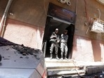 Security members stand at the scene where a deadly fire broke out at the Abu Sifin church in Giza, Egypt.