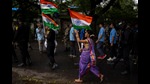 A girl walks carrying Indian flag along with army soldiers during a ceremony to celebrate 75 years of India's Independence in Mumbai, August 14, 2022 (AP) A girl walks carrying Indian flag along with army soldiers during a ceremony to celebrate 75 years of India's Independence in Mumbai, August 14, 2022 (AP)