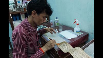 A conservator is seen working on the repair and restoration work of the manuscripts at Bhandarkar Oriental Research Institute (Bori) on Saturday. (HT PHOTO) A conservator is seen working on the repair and restoration work of the manuscripts at Bhandarkar Oriental Research Institute (Bori) on Saturday. (HT PHOTO)