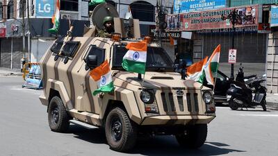Srinagar, Aug 14 (ANI): A CRPF jawan on an armored vehicle during a rally as part of the celebrations to mark the 75th anniversary of Independence under the 'Har Ghar Tiranga' campaign, in Srinagar on Sunday. (ANI Photo) (Imran Nissar)