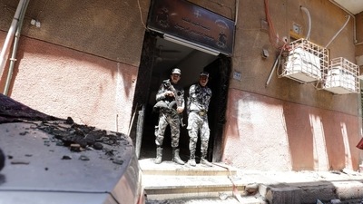 Security members stand at the scene where a deadly fire broke out at the Abu Sifin church in Giza, Egypt. (Reuters) Security members stand at the scene where a deadly fire broke out at the Abu Sifin church in Giza, Egypt. (Reuters)