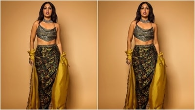 Bhumi's backless scarf top comes in a black and silver hue. It features a plunging U neckline, spaghetti straps extending to the back to form criss-cross details, an asymmetric hemline, sequinned embellishments, and horizontal stripes. (Instagram) Bhumi's backless scarf top comes in a black and silver hue. It features a plunging U neckline, spaghetti straps extending to the back to form criss-cross details, an asymmetric hemline, sequinned embellishments, and horizontal stripes. (Instagram)