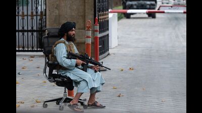 A Taliban fighter guards a gate after a gathering attended by Afghanistan's Prime Minister Mohammad Hassan Akhund and Minister for Promotion of Virtue and Prevention of Vice Sheikh Mohammad Khalid at the former presidential palace, Kabul, August 13, 2022 (AFP) A Taliban fighter guards a gate after a gathering attended by Afghanistan's Prime Minister Mohammad Hassan Akhund and Minister for Promotion of Virtue and Prevention of Vice Sheikh Mohammad Khalid at the former presidential palace, Kabul, August 13, 2022 (AFP)