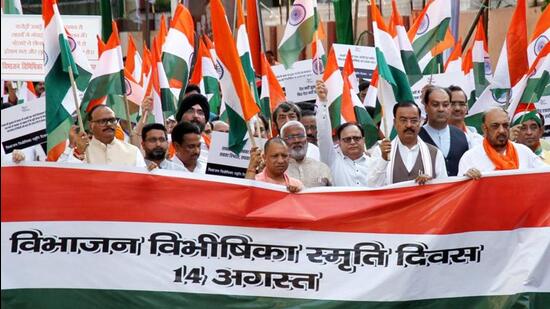 Uttar Pradesh chief minister Yogi Adityanath along with deputy CMs Brajesh Pathak and Keshav Prasad Maurya and party leaders Swatantra Dev Singh and others participate in a silent procession in remembrance of ‘Vibhajan Vibhishika Smriti Diwas’ from Lok Bhavan to GPO park, in Lucknow on Sunday. (ANI PHOTO)