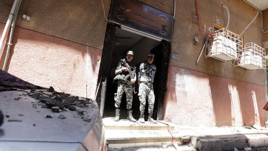 Security members stand at the scene where a deadly fire broke out at the Abu Sifin church in Giza, Egypt.(Reuters)