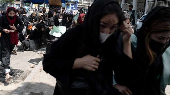 Taliban fighters fire in air to disperse Afghan women protesters in Kabul.(AFP)