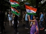 A girl walks carrying Indian flag along with army soldiers during a ceremony to celebrate 75 years of India's Independence in Mumbai, August 14, 2022 (AP) A girl walks carrying Indian flag along with army soldiers during a ceremony to celebrate 75 years of India's Independence in Mumbai, August 14, 2022 (AP)