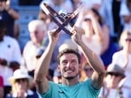 Pablo Carreno Busta, of Spain, hoists the trophy after defeating Hubert Hurkacz, of Poland, in the final of the National Bank Open tennis tournament