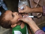 A health worker administers polio drops to a child during a polio vaccination campaign in Karachi on August 15, 2022. (Photo by Rizwan TABASSUM / AFP)(AFP) A health worker administers polio drops to a child during a polio vaccination campaign in Karachi on August 15, 2022. (Photo by Rizwan TABASSUM / AFP)(AFP)