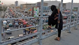 A Taliban fighter stands guard on a bridge in Kabul, Afghanistan, 